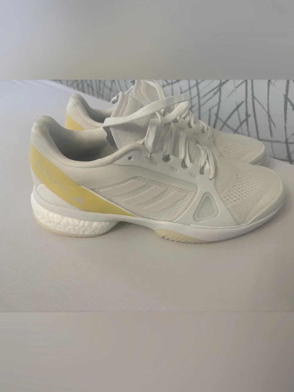 adidas Avaluxe tennis shoes in white with subtle pastel yellow accents. JQ7080